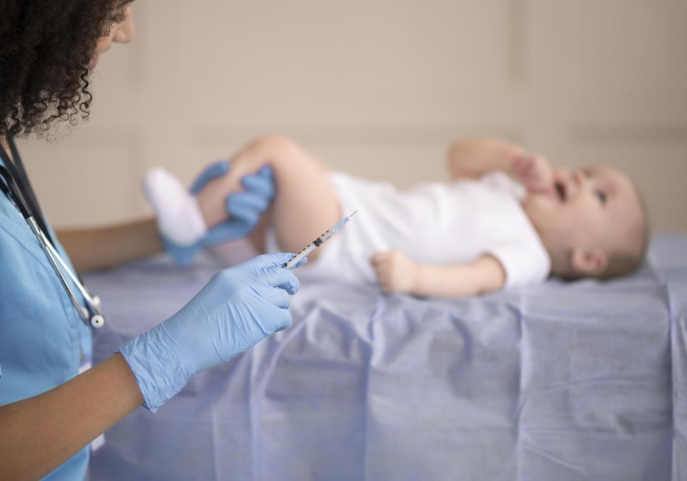 Premature infant with apnea of prematurity, lying in a hospital crib with medical monitoring equipment.