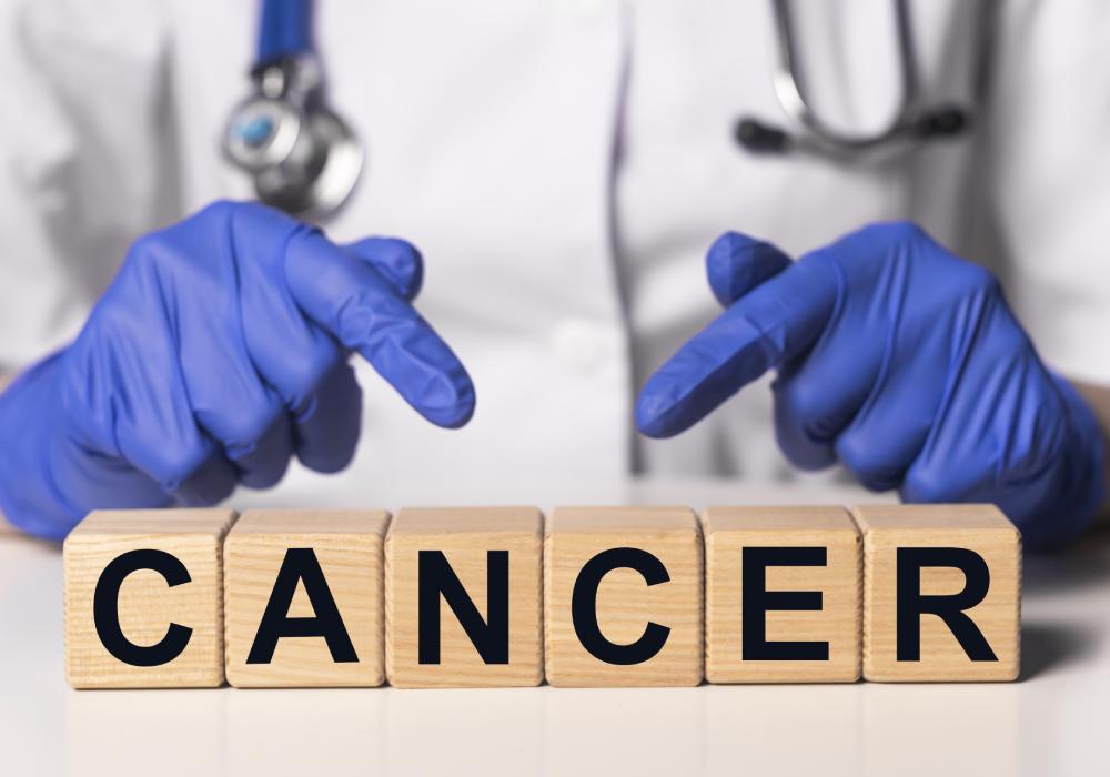 Doctor holding a small board displaying the words 'Cancer Prevention', emphasizing the importance of proactive health measures.