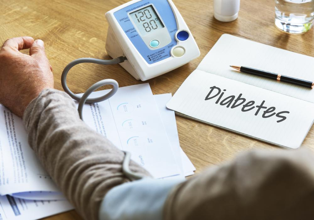 Doctor checking blood glucose level of a diabetic patient using glucometer.