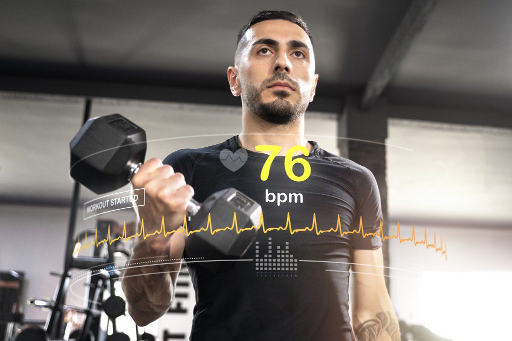 Image of a man engaged in a workout, performing exercises with dumbbells.